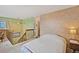 Cozy bedroom with ensuite bathroom, ceiling fan, and neutral decor on the upper level of the home at 10530 W Jewell Ave # 303, Lakewood, CO 80232