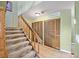 Carpeted stairs leading to a tiled entryway featuring wood closets and fresh paint at 10530 W Jewell Ave # 303, Lakewood, CO 80232