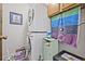Efficient laundry area featuring stacked washer and dryer for space-saving convenience and functional design at 10530 W Jewell Ave # 303, Lakewood, CO 80232