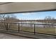 Balcony overlooking the calm lake and park with birds and bare trees on a sunny day at 10530 W Jewell Ave # 303, Lakewood, CO 80232