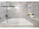 Clean bathroom featuring a soaking tub with stylish gray tile and contemporary fixtures at 315 Arapahoe Ave # 202, Boulder, CO 80302