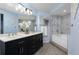 Elegant bathroom featuring double sinks, dark cabinets, and a separate shower and tub at 315 Arapahoe Ave # 202, Boulder, CO 80302