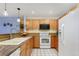 Inviting kitchen featuring wooden cabinetry, granite countertops with stainless steel appliances at 315 Arapahoe Ave # 202, Boulder, CO 80302