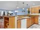 Bright kitchen featuring wooden cabinetry, granite countertops and adjacent living area at 315 Arapahoe Ave # 202, Boulder, CO 80302