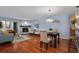 Open-concept living area with fireplace, hardwood floors, and a dining table near the bar area at 315 Arapahoe Ave # 202, Boulder, CO 80302