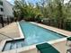 Community pool with a fence surrounded by lush trees at 315 Arapahoe Ave # 202, Boulder, CO 80302