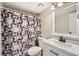 Bathroom with a white vanity, patterned shower curtain, and a large mirror at 931 S Zeno Way # 107, Aurora, CO 80017