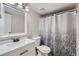 Bright bathroom with a white vanity and patterned shower curtain at 931 S Zeno Way # 107, Aurora, CO 80017