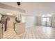 Bright open-concept living room and kitchen area with light-colored walls at 931 S Zeno Way # 107, Aurora, CO 80017