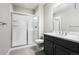 Modern bathroom featuring a glass-enclosed shower and dark-stained vanity with white countertop at 5695 Cadara Way, Parker, CO 80134