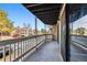 Spacious balcony features stone accents, a covered ceiling, and views of the community's exterior at 18004 E Ohio Ave # 101, Aurora, CO 80017