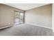 Bright bedroom featuring a sliding glass door to a balcony and neutral carpeting at 18004 E Ohio Ave # 101, Aurora, CO 80017