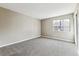 Bright bedroom with neutral walls and a view of the neighborhood at 18004 E Ohio Ave # 101, Aurora, CO 80017