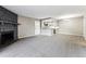 Open living room and kitchen area with stone fireplace and dining at 18004 E Ohio Ave # 101, Aurora, CO 80017