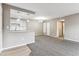 Living room with kitchen island and modern lighting fixtures at 18004 E Ohio Ave # 101, Aurora, CO 80017