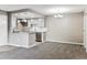 Open floor plan with living room and kitchen featuring modern gray cabinets at 18004 E Ohio Ave # 101, Aurora, CO 80017