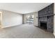 Spacious living room featuring a fireplace and sliding doors to the balcony at 18004 E Ohio Ave # 101, Aurora, CO 80017