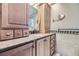 Bathroom with granite countertop and wood cabinets at 7358 S Ridgeview Dr, Littleton, CO 80120