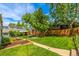 Beautifully landscaped backyard with lush green lawn and mature trees, perfect for outdoor enjoyment at 3116 S Lincoln St, Englewood, CO 80113