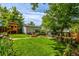 Backyard features an expansive lawn, garage, and custom-built playhouse at 3116 S Lincoln St, Englewood, CO 80113