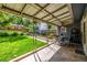 Covered patio and yard with manicured lawn, landscaping, and view of detached garage at 3116 S Lincoln St, Englewood, CO 80113