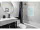 Modern bathroom featuring stylish fixtures, oval mirror, tiled walls, and a shower with black curtain at 3116 S Lincoln St, Englewood, CO 80113