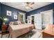 Stylish bedroom with dark blue walls, a ceiling fan, and en-suite bathroom, creating a cozy retreat at 3116 S Lincoln St, Englewood, CO 80113