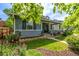 Quaint single-Gathering home with a welcoming front porch, well-maintained lawn, and beautiful landscaping at 3116 S Lincoln St, Englewood, CO 80113