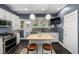 Well-lit kitchen featuring a center island, stainless steel appliances, and views of the backyard, ideal for cooking at 3116 S Lincoln St, Englewood, CO 80113