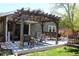 Inviting back porch with comfortable seating under a rustic pergola at 8101 S San Juan Range Rd, Littleton, CO 80127