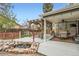 Backyard patio featuring a covered seating area with pond and water feature at 8101 S San Juan Range Rd, Littleton, CO 80127