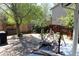 Spacious backyard with mature trees, a rock water feature, and patio at 8101 S San Juan Range Rd, Littleton, CO 80127