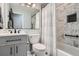 Modern bathroom with elegant fixtures, a tub and shower, and a sleek vanity at 8101 S San Juan Range Rd, Littleton, CO 80127