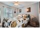 Cozy bedroom featuring a large window, ceiling fan, and stylish furnishings at 8101 S San Juan Range Rd, Littleton, CO 80127