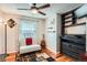 Comfortable bedroom with hardwood floors, a ceiling fan, and a cozy seating area at 8101 S San Juan Range Rd, Littleton, CO 80127