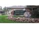 Ken-Caryl Ranch community center sign sits above a stone wall surrounded by green foliage at 8101 S San Juan Range Rd, Littleton, CO 80127