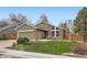 Charming home with a brick exterior, well-kept lawn, large windows, and a cozy front patio at 8101 S San Juan Range Rd, Littleton, CO 80127