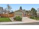 This cozy home features a well-manicured lawn, a two-car garage, and charming brick accents at 8101 S San Juan Range Rd, Littleton, CO 80127