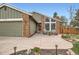 Lovely home with a quaint front patio, stamped concrete walkway, and beautifully landscaped front yard at 8101 S San Juan Range Rd, Littleton, CO 80127
