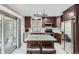 Modern kitchen with stainless steel appliances, granite countertops, and stylish island seating at 8101 S San Juan Range Rd, Littleton, CO 80127