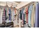 Organized walk-in closet featuring ample storage space and shelving for clothing and accessories at 8101 S San Juan Range Rd, Littleton, CO 80127