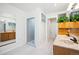 Bright bathroom with walk-in shower, dual sinks, and tile floor at 32392 Lodgepole Dr, Evergreen, CO 80439