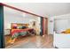 Bright bedroom showcasing hardwood floors, colorful bedding, and access to a room and closet at 32392 Lodgepole Dr, Evergreen, CO 80439