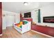 Cozy bedroom with a daybed, mounted TV, and decorative fireplace for a relaxing retreat at 32392 Lodgepole Dr, Evergreen, CO 80439