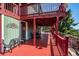 Relaxing covered outdoor deck featuring dining and seating areas with scenic views at 32392 Lodgepole Dr, Evergreen, CO 80439