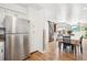 Open dining area with stainless steel refrigerator and sliding barn door at 32392 Lodgepole Dr, Evergreen, CO 80439