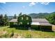 Charming barn style home with lush greenery, mountain views, and an inviting exterior at 32392 Lodgepole Dr, Evergreen, CO 80439