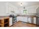 Bright kitchen with stainless steel appliances and wood floors at 32392 Lodgepole Dr, Evergreen, CO 80439