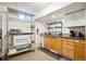 Basement kitchenette with stainless steel appliances and wooden cabinets at 32392 Lodgepole Dr, Evergreen, CO 80439