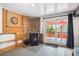 Living Room featuring stone accent wall, wood burning stove and sliding doors to deck at 32392 Lodgepole Dr, Evergreen, CO 80439
